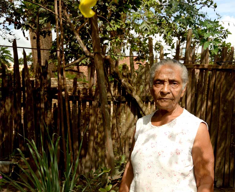 Adelia Marinho de Souza in her cottage garden, her sanctuary from the urban world that has replaced the sleepy Amazon settlement in which she once lived. Photo by Natalia Guerrero.